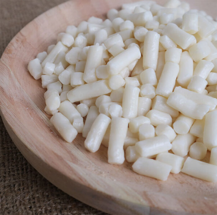 Raw soap noodles in a wooden bowl — base material for every Vascali bar